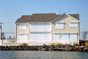 Storm shutters on a water-front home.