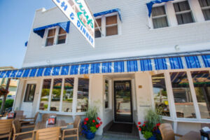 Blue and white striped awning on a white commercial building