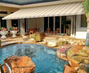 Retractable awning in landscaped backyard