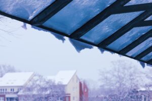 Snow and icicles hanging from awning 