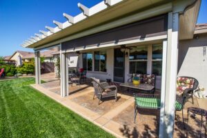 Backyard patio with chairs and retractable screen