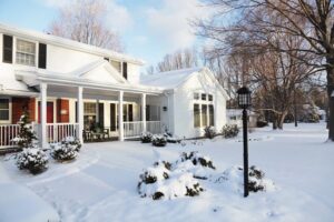 Suburban house covered in winter snow