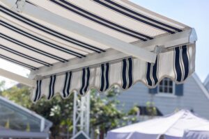 Extended retractable fabric awning over backyard 